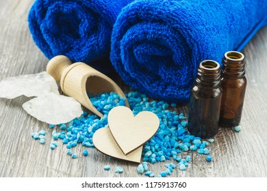 Wooden Heart Put On The Wooden Table With A Blue Towel. Spa Concept.