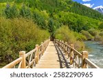 The wooden hiking path runs along Pearl Shoal Falls, Jiuzhaigou National Park, Sichuan, China.