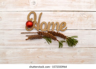 Wooden Home Red Christmas Ball Ornament With Bottlebrush (Callistemon) Plant Seed Pods On Whitewashed Wood Background Table