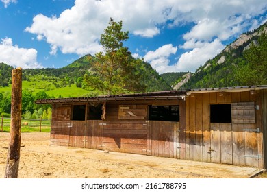 wooden horse field shelter in the mountains