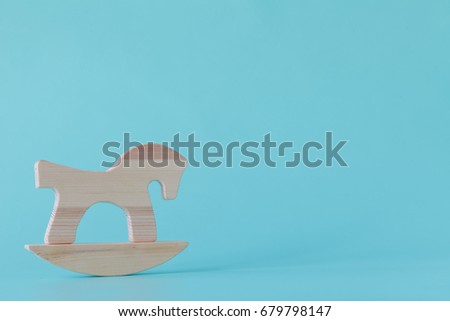 wooden horse toy isolated on aquamarine