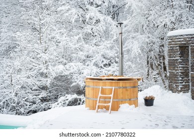 Wooden Hot Vat On Snowy Terrace At Mountains. Winter Vacation Concept With Hot Bath Outside