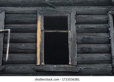 Wooden House After The Fire. Coals On The Logs. The Ashes Of The House From Fire. Burnt Destroyed Cottage.