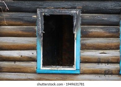 Wooden House After The Fire. Coals On The Logs. The Ashes Of The House From Fire. Burnt Destroyed Cottage.