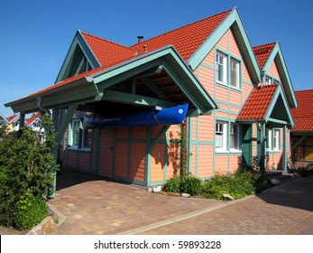 Wooden House With Carport And Boat