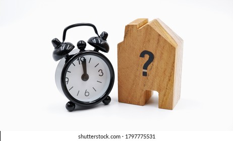 Wooden House With Clock, Business Concept Of Housing Market Trends And Property Value. When Is The Best Time To Buy House Or Real Estate Investment After Financial Impact From Coronavirus Crisis.