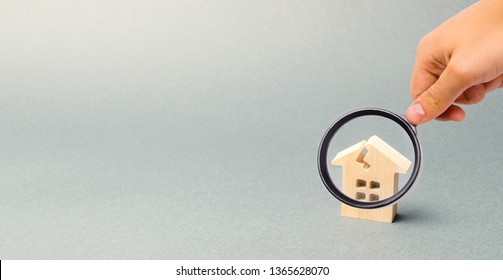 A Wooden House With A Crack. The Concept Of A Damaged House, Dilapidated Housing. Home Repair After Disaster. Renovation, Restoration Of The Old Building. Property Insurance. Damage. Weather Element.