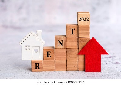 Wooden House And Wooden Cubes With 2022 Rent  Word And Red Up Arrow .Increasing  Property Rent Price  Concept