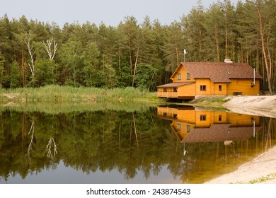 Wooden House In The Forest Above The Lake