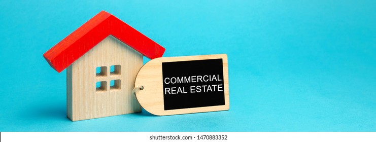 Wooden House With The Inscription Commercial Real Estate. Buildings Intended To Generate A Profit, Capital Gain Or Rental Income. Multifamily Housing Buildings, Offices. Commercial Property