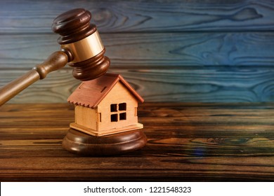 Wooden House. Judge's Gavel On Wooden Background. Pledge, Arrest Of Real Estate.