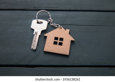 wooden house model with key on table