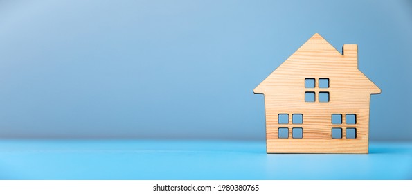 wooden house model on blue background