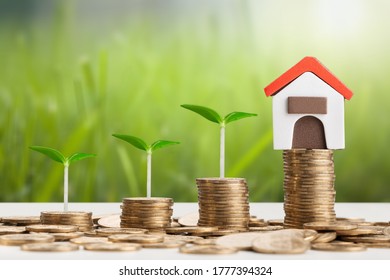 Wooden house model on money coins for concept investment - Shutterstock ID 1777394324