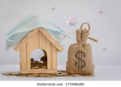 The wooden house model wears a mask to protect against corona virus and various diseases. Place it on a gold coin next to the money bag, save money to buy health insurance ideas, work at home.