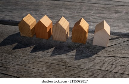 Wooden House Models On Tree Stump In The Outdoors. Concept Image For Wood As A Renewable And Sustainable Building Material For Modular Timber Architecture. 