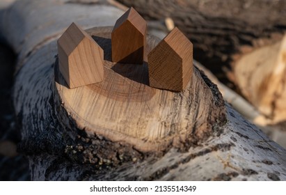 Wooden House Models On Tree Stump In The Outdoors. Concept Image For Wood As A Renewable And Sustainable Building Material For Modular Timber Architecture. 