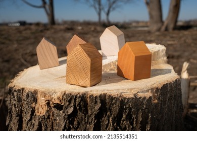 Wooden House Models On Tree Stump In The Outdoors. Concept Image For Wood As A Renewable And Sustainable Building Material For Modular Timber Architecture. 