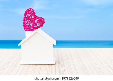 Wooden House With Pink Heart Over Blurred Beach Background, New House, Buy Or Sell Resident Business, Summer Home