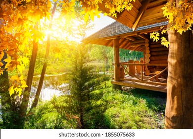 Wooden house and pond at the autumn