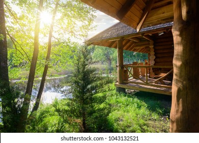 Wooden house and river - Shutterstock ID 1043132521