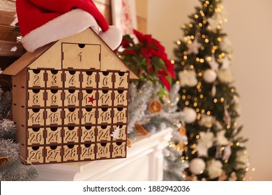 Wooden House Shaped Advent Calendar In Room Decorated For New Year