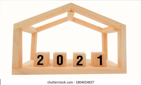 Wooden House Shaped Frame With 2021 Wooden Blocks, Isolated On White Background. Real Estate Concept Of Housing Market Trends After Financial Crisis From Coronavirus Impact.