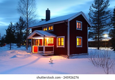 Wooden House In Sweden During Winter By Night