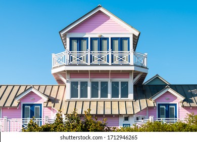 Wooden house tower architecture by beach ocean nobody in Florida view during sunny day with pink color of new urbanism design and blue sky