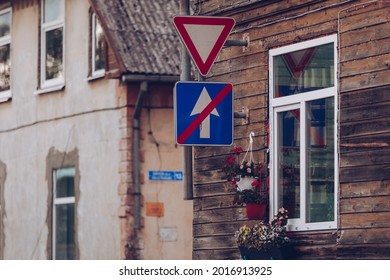 Wooden House With White Window Near By The Give A Road And End Of The One Way Road Sign