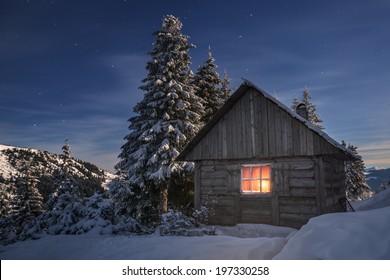 Wooden House In Winter Forest