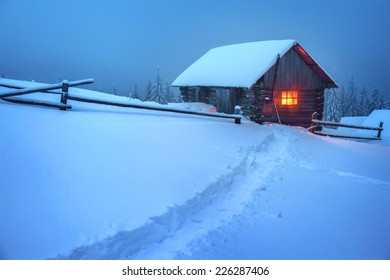 Wooden House In Winter Forest