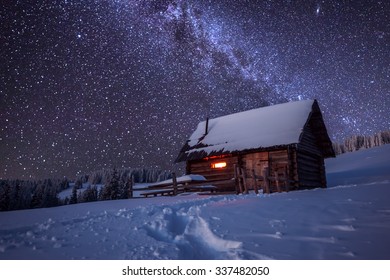 Wooden House In Winter Forest