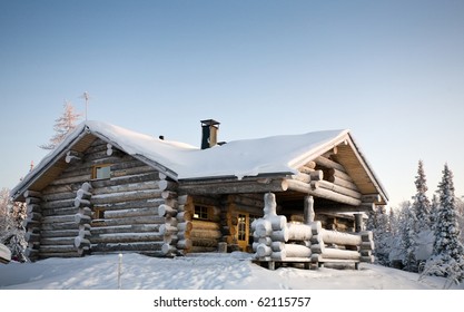 Wooden House In Winter Forest