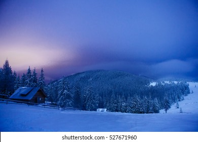 Wooden House In Winter Forest In Crrpathian Mountains  , At Night