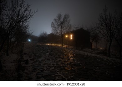 Wooden House In Winter Forest. Mountain House In The Snow At Night. Misty Night. Long Exposure Shot