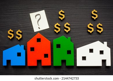 Wooden Houses And Dollar Signs.Estimate Home Value Concept.