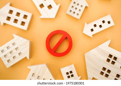 Wooden houses and a prohibition sign. Inaccessible and expensive housing. Restrictions and a ban on the construction of buildings. Interdictions within settlements. - Shutterstock ID 1975180301