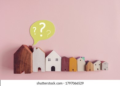 Wooden Houses With Question Marks, Housing Crisis, Confused Decision, Insecure Investment, Choosing Right Property Concept