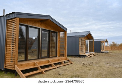 Wooden houses in a triangular summer camp. summer vacation in an eco-friendly house, summer - Powered by Shutterstock