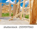 Wooden houses under construction. Frames of buildings made of planks. Erection cottages using frame method. Construction of wooden residential buildings. Erection of timber cottages