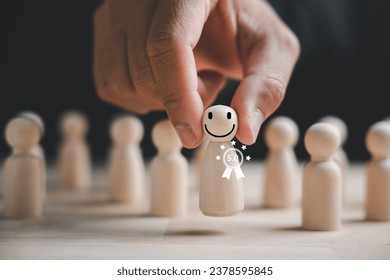 Wooden human figure firmly held by man hand. HR officer looks for leader and CEO. Leader emerges from the crowd. Personal development, motivation, challenge. HR, HRM, HRD concepts. - Shutterstock ID 2378595845