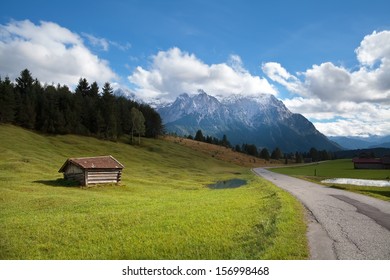 wooden hut on meadow and high Bavarian alps, Germany