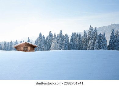 Wooden hut in a snowy winter landscape - Powered by Shutterstock