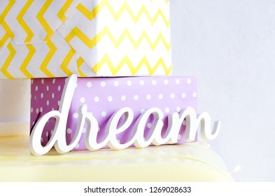 Wooden inscription dream with two gifts. - Powered by Shutterstock