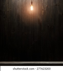 wooden interior room with classic Edison light bulb on wooden background switched on. retro edison light bulb