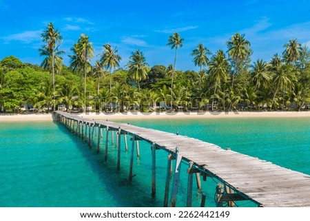Wooden jetty (bridge) to beautiful tropical beach