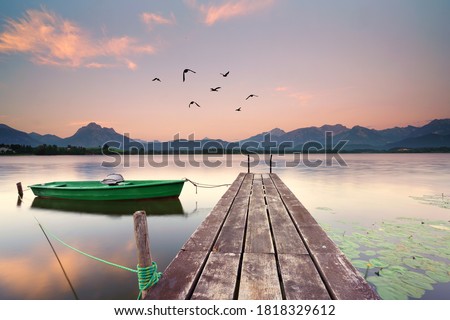 wooden jetty at the lake, boat on the lake