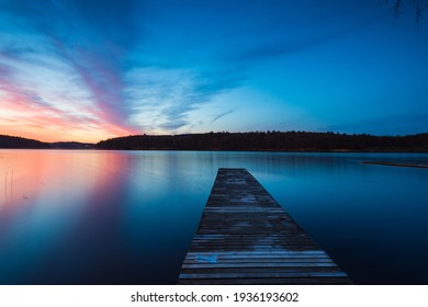 Wooden Jetty At Lake During Sunrise