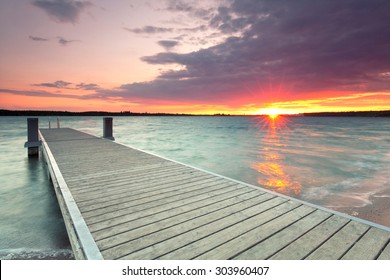 wooden jetty at lake, photographed in the evening, sunset in summer  - Powered by Shutterstock